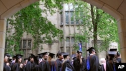 FILE - In this May 24, 2010 file photo, future graduates wait for the procession to begin for commencement at Yale University in New Haven, Conn. The Biden Justice Department says it is dismissing its discrimination lawsuit against Yale University. (AP Photo)