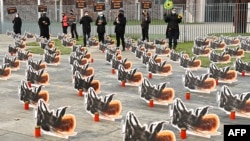 FILE - Environmental activists of Campact group stage a protest with some 200 oversized cardboard bees installed in front of the Chancellery on December 2, 2020 in Berlin, to call for more insect protection. (Photo by Tobias Schwarz / AFP)
