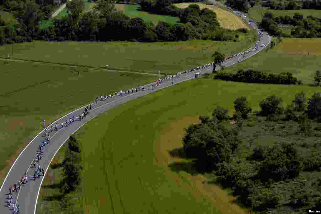 People join hands to form a 202 km (125 miles) long, according to organizers, human chain linking the cities of San Sebastian, Vitoria and Bilbao to call for a right to vote on Basque independence, near Vitoria, Spain.