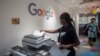 FILE - A woman makes copies at the Google Artificial Intelligence (AI) office in Accra, on Apr. 10, 2019. 
