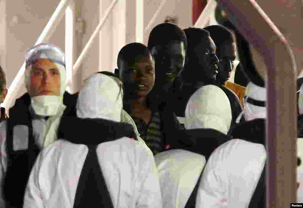 Surviving immigrants arrive by Italian Coast Guard ship Bruno Gregoretti at the port of Catania, April 21, 2015.