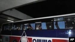 Repatriated domestic workers from the Philippines wait to return to the Overseas Workers Welfare Administration halfway house where they will receive counseling after returning from conflict-torn Syria. February 28, 2012 at Ninoy Aquino International Airp