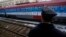 A railroad worker stands by the first train decorated with letters that read "Kosovo is Serbian" written in twenty languages departing from Belgrade to Mitrovica, Kosovo, Jan. 14, 2017.