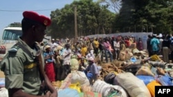 FILE - Refugees from Central Africa Republic wait for a food distribution at an UNHCR refugee camp in the eastern Cameroonian city of Garoua-Boulai, not far from the border with Central Africa Republic, March 13, 2014. 