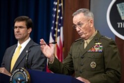 Joint Chiefs Chairman Gen. Joseph Dunford, with Secretary of Defense Mark Esper, speaks to reporters during a briefing at the Pentagon, Aug. 28, 2019.