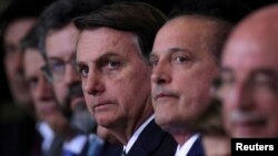 Brazil's President Jair Bolsonaro looks on during the ceremony of the 300 days of government at the Planalto Palace, in Brasilia, Brazil, Nov. 5, 2019. 