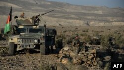 FILE - Afghan security forces take positions following an operation against Islamic State militants in Pachir Wa Agam district of Nangarhar province, Dec. 3, 2016.