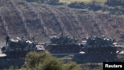 Turkish army tanks are seen near the Turkish-Syrian border in Kilis province, Turkey, Jan. 31, 2018. 