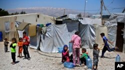Syrian refugee children play outside their family tents at a Syrian refugee camp in the town of Bar Elias, in Lebanon's Bekaa Valley, April 23, 2018.