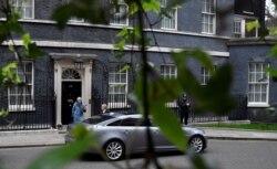 FILE - Britain's Prime Minister Theresa May leaves 10 Downing Street, as she faces a vote on alternative Brexit options, in London, March 27, 2019.