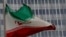 FILE - An Iranian flag flutters in front of the International Atomic Energy Agency (IAEA) headquarters in Vienna, Austria, Sept. 9, 2019. 