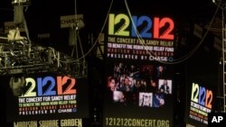 Signage for the "12-12-12" concert is displayed on the Madison Square Garden jumbotron in New York, December 11, 2012.