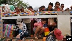 Cambodian migrant workers get off a Thai truck upon their arrival from Thailand at a Cambodia-Thailand's international border gate in Poipet, Cambodia, June 17, 2014.