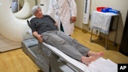 Judith Chase Gilbert, of Arlington, Va., is loaded into PET scan machine by Nuclear Medicine Technologist J.R. Aguilar as part of a study on Allheimer's disease at Georgetown University Hospital, on Tuesday, May 19, 2015.