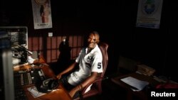 Communications student Mohamed Alpha Ba, 21, poses for a picture in the studio of the radio station he volunteers with, at Sierra Leone's prestigious Fourah Bay College in the capital Freetown, November 2012.