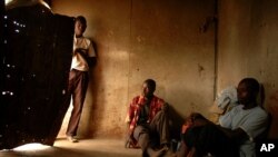 FILE - Illegal Zimbabwean immigrants who work as farm laborers are seen inside their room on a farm near the Beitbridge border post, between South Africa and Zimbabwe, in the Limpopo Province, in March 2006.