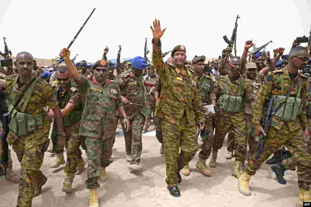 Mkuu wa jeshi la Sudan Abdel Fattah al-Burhan atembea wanajeshi kwenye kambi ya jeshi la majini la Flamingo, mjini Port Sudan hapo Ogusti 28, 2023. Hii ni mara ya kwanza kuonekana kwa kiongozi huyo tangu kuanza vita nchin i mwake April 15, 2023.