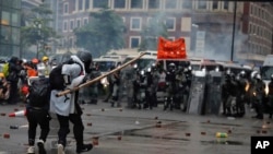 Protesters use bamboo sticks as they face riot police during a protest in Hong Kong, Aug. 25, 2019.