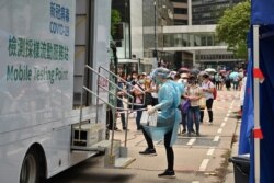 Migrant workers queue up for Covid-19 testing in the Central district of Hong Kong, May 1, 2021.