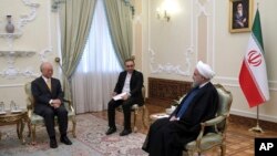 In this photo released by the office of the Iranian Presidency, President Hassan Rouhani, right, speaks with Director General of the International Atomic Energy Agency, IAEA, Yukiya Amano, left, during their meeting, in Tehran, Iran, Oct. 29, 2017.