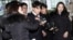 Seungri, center, member of a popular K-pop boy band Big Bang, arrives at the Seoul Metropolitan Police Agency in Seoul, South Korea, March 14, 2019.