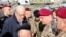 Lebanon's caretaker Prime Minister Najib Mikati (2nd-L) and Lebanese army commander, General Joseph Aoun (2nd-R), visit the southern Lebanese village of Khiam on Dec. 23, 2024, after the withdrawal of Israeli forces from the area. 