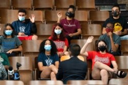 Health Commissioner Dr. Dave Chokshi, center, joins students at Lehman High School for a roundtable discussion about the COVID-19 vaccine, in New York, July 27, 2021.