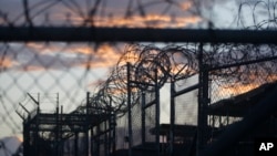 FILE - Dawn arrives at the now closed Camp X-Ray at Guantanamo Bay Naval Base, Cuba, Nov. 21, 2013. Camp X-Ray was the first facility in which the U.S. military held terror suspects.