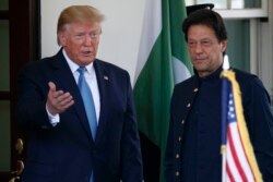 FILE - President Donald Trump gestures as he greets Pakistan's Prime Minister Imran Khan as he arrives at the White House, in Washington, July 22, 2019.