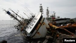 A partially capsized fishing ship is seen after Typhoon Meranti made landfall, in Kaohsiung, Taiwan, September 15, 2016. 