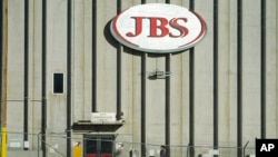 A worker heads into the JBS meatpacking plant Monday, Oct. 12, 2020, in Greeley, Colo.