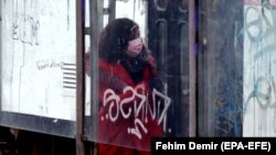BOSNIA-HERZEGOVINA -- A woman wearing face mask walks on a street in the midst of the coronavirus disease (COVID-19) pandemic, in Sarajevo, December 18, 2020