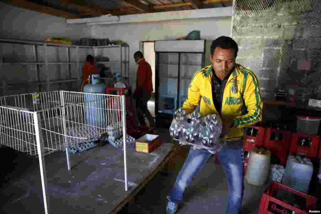 A foreign national clears items from his shop for fear of attacks in Primrose outside Johannesburg, April 16, 2015.