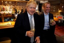 Boris Johnson, a leadership candidate for Britain's Conservative Party, and Britain's former Brexit Minister Dominic Raab visit a pub in Oxshott.