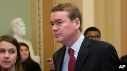 FILE - Sen. Michael Bennet, D-Colo., leaves the chamber at the Capitol in Washington on Jan. 24, 2019.