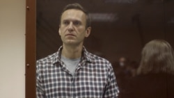 Kremlin critic Alexei Navalny stands inside a defendant dock during a court hearing in Moscow, Russia, Feb. 20, 2021, in this still image taken from video. (Press Service of Babushkinsky District Court of Moscow/Handout)