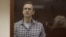 FILE - Kremlin critic Alexey Navalny stands inside a defendant dock during a court hearing in Moscow, Russia, Feb. 20, 2021, in this still image taken from video. (Press Service of Babushkinsky District Court of Moscow/Handout)