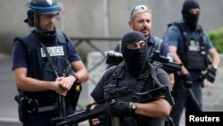 French police and anti-crime brigade (BAC) members secure a street as they carried out a counter-terrorism swoop at different locations in Argenteuil, a suburb north of Paris, France, July 21, 2016. 