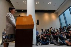Hong Kong Chief Executive Carrie Lam, left, speaks during a press conference in Hong Kong, Tuesday, Nov. 26, 2019.