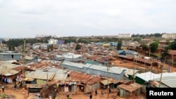 Children are seen playing at an empty space amid the coronavirus disease (COVID-19) outbreak within the Kibera settlement in Nairobi, Kenya, July 18, 2021.