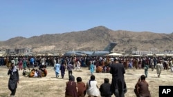 Ratusan warga Afghanistan tampak memadati area Bandara Internasional Kabul pada 16 Agustus 2021, berharap agar dapat dievakuasi dengan pesawat Angkatan Udara AS. (Foto: AP/Shekib Rahmani)