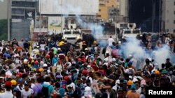 Opposition supporters clash with riot police during a rally against President Nicolas Maduro in Caracas, Venezuela, May 8, 2017. 