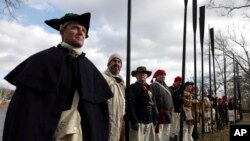 Troops gather during a re-enactment of Gen. George Washington's daring Christmas 1776 crossing of the Delaware River, Monday, Dec. 25, 2017, in Washington Crossing, Pa.