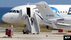A man believed to be the hijacker of the EgyptAir Airbus A-320, which was diverted to Cyprus, leaves the plane before surrendering to security forces after a six-hour standoff on the tarmac at Larnaca airport's largely disused old terminal on March 29, 20