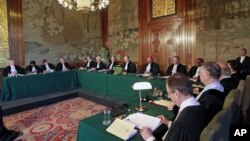 Presiding judge of the Court Peter Tomka (eighth from left) reads the verdict at the International Court of Justice in The Hague, Netherlands, July 20, 2012, ordering the prosecution of former Chadian dictator Hissene Habre.