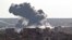 Smoke rises over the Syrian city of Kobani, following a US led coalition airstrike, seen from outside Suruc, on the Turkey-Syria border, Nov. 10, 2014. Kobani, also known as Ayn Arab, and its surrounding areas, has been under assault by extremists of the Islamic State group since mid-September and is being defended by Kurdish fighters. (AP Photo/Vadim Ghirda)