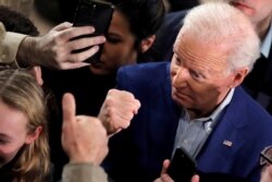 Democratic 2020 U.S. presidential candidate and former Vice President Joe Biden gestures as he talks with a supporter during a campaign event in Manchester, New Hampshire, Feb. 10, 2020.