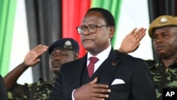 Malawi's President Lazarus Chakwera, center, has pardoned former Homeland Security minister Uladi Mussa who was jailed in 2020 for corruption, April 10, 2023. Mussa was among 200 prisoners released as an act of mercy during Easter.