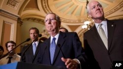Senate Minority Leader Mitch McConnell, center, accompanied by, from left, Senators John Thune, John Barrasso and Senate Minority Whip John Cornyn, Capitol Hill, Washington, Sept. 24, 2013.