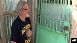 Michael Geilanfeld, who runs St. Joseph's house for former child slaves and street children in Port-au-Prince, shows some of the damage from last year's earthquake.